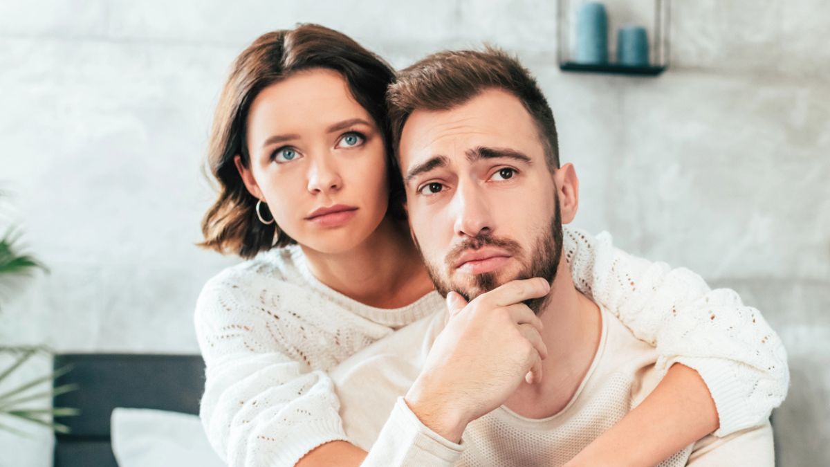 couple sad hugging together