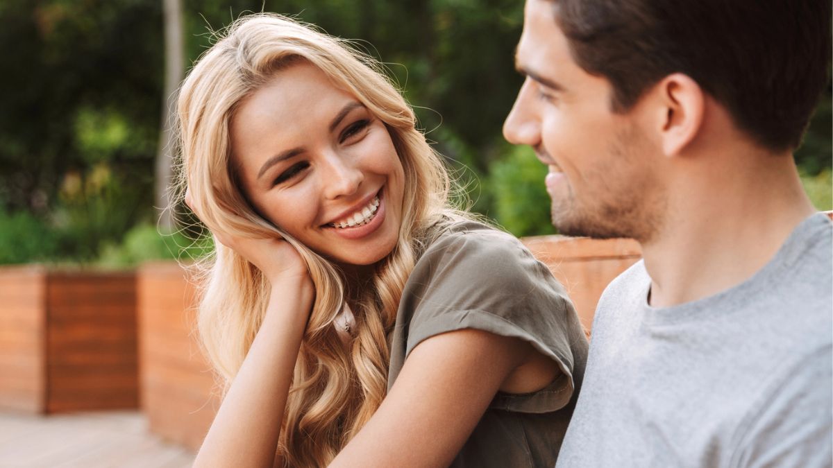 couple smiling outside on cement
