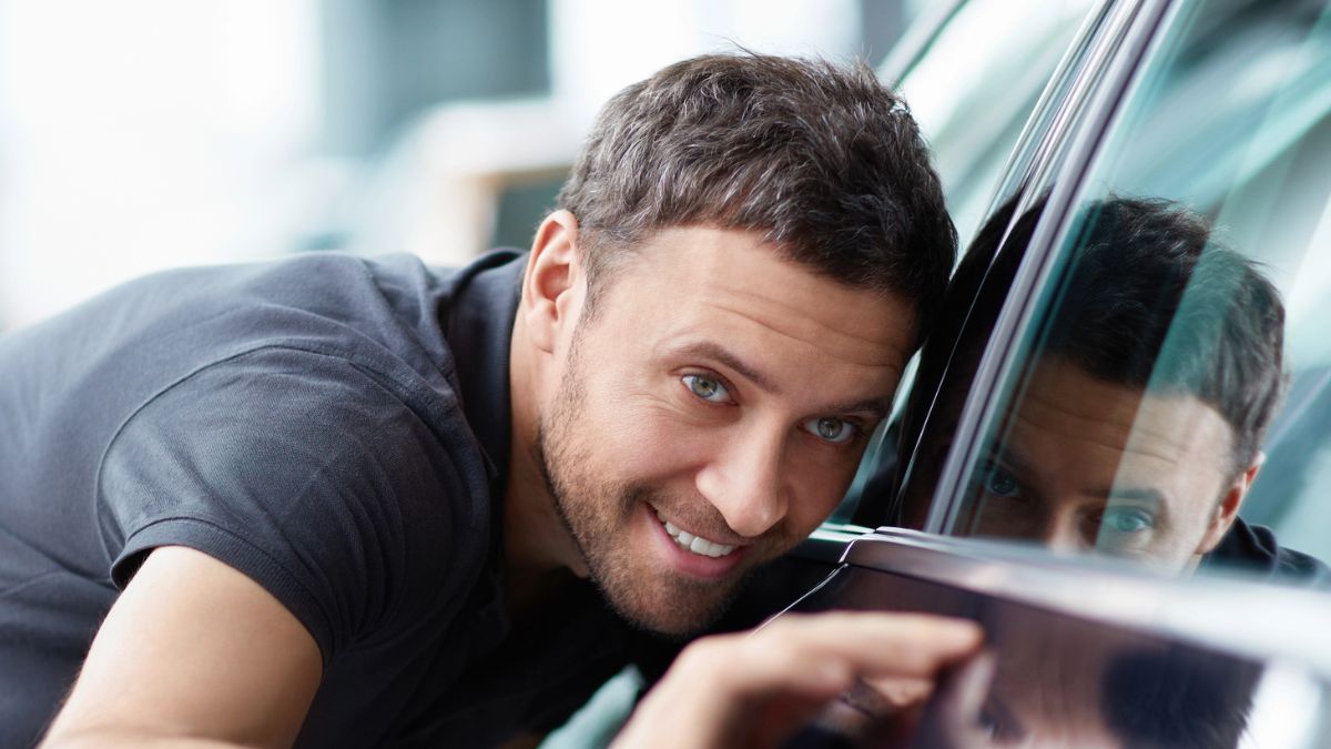 guy looking at car