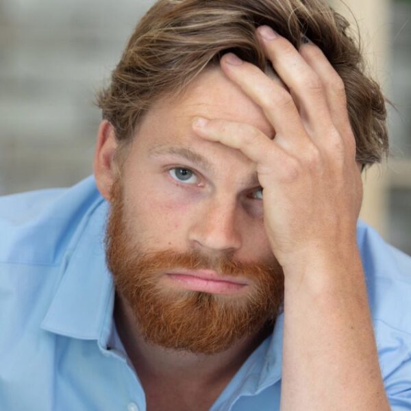 man beard leaning on desk