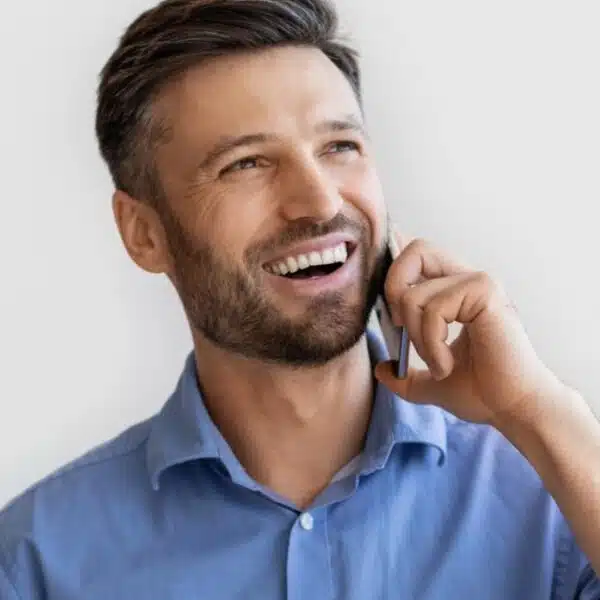 man blue shirt talking on the phone