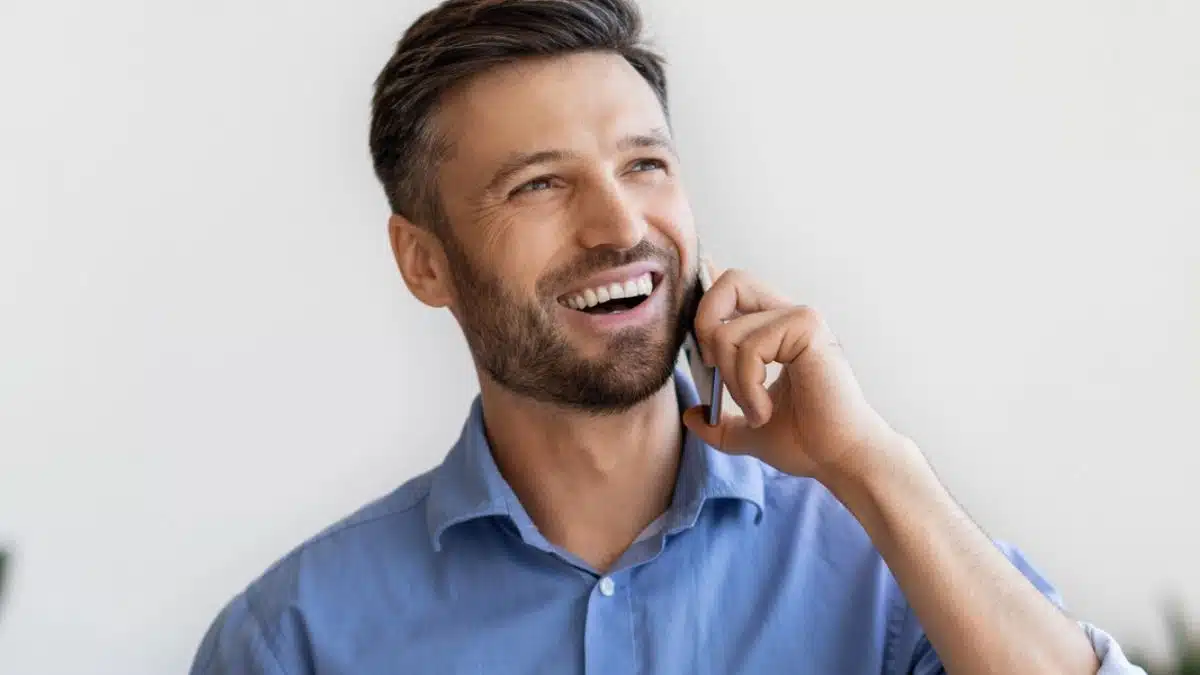 man blue shirt talking on the phone