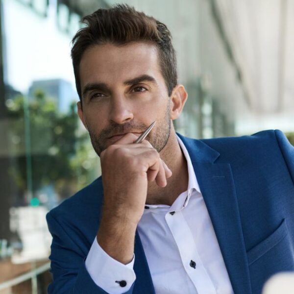 man sitting outside business