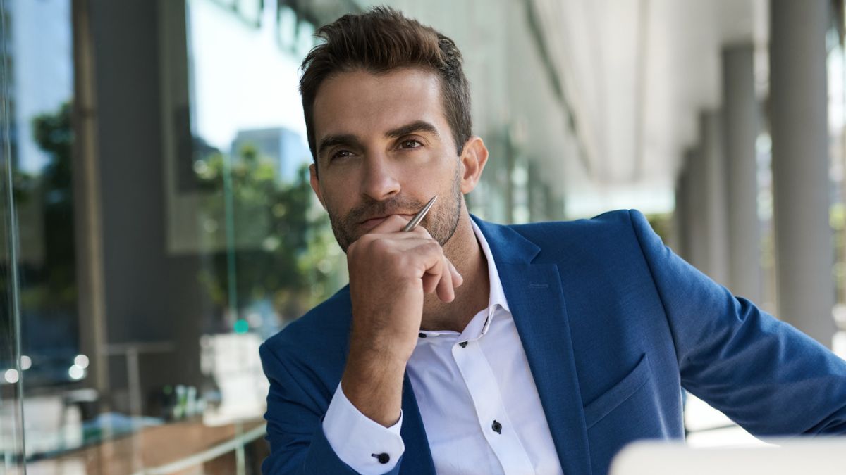 man sitting outside business