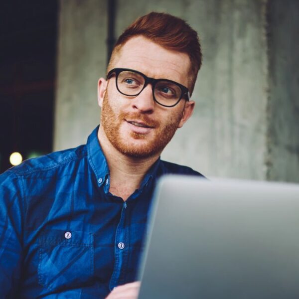 man sitting outside with a laptop