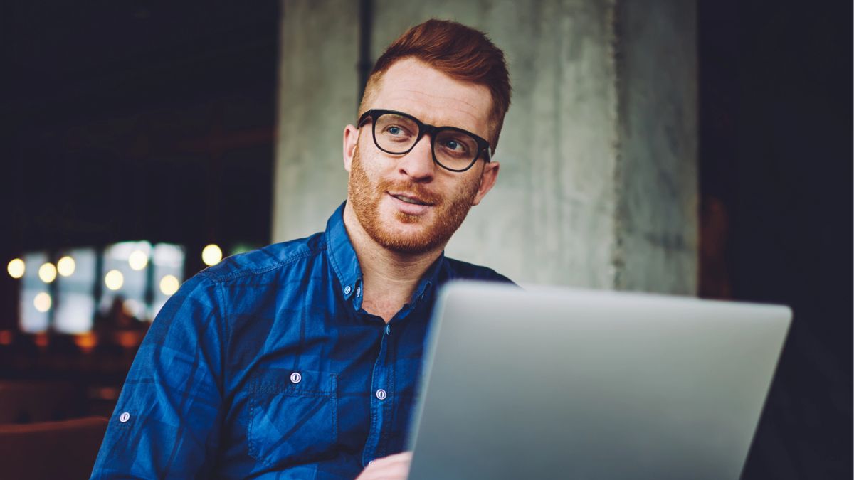 man sitting outside with a laptop