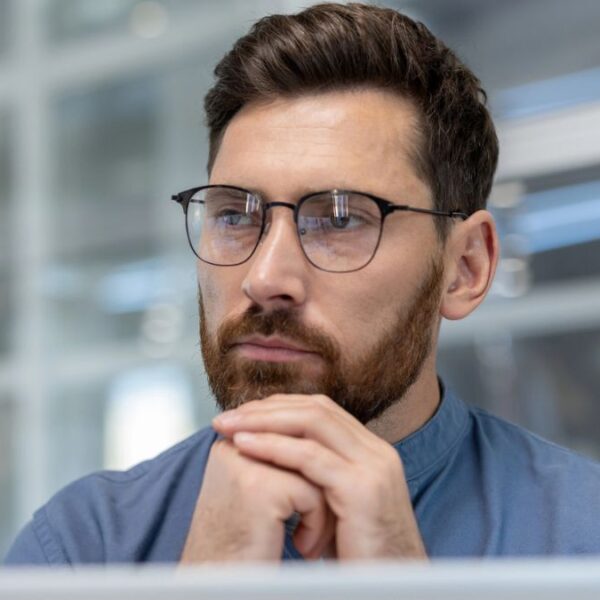 man thinking at his desk