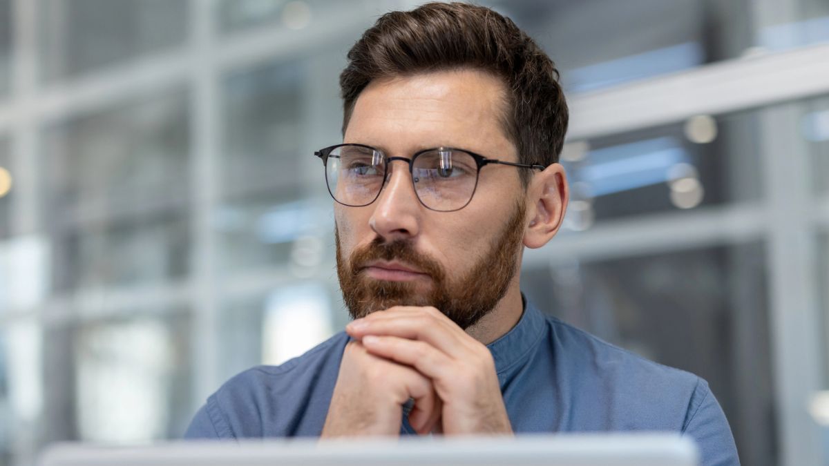 man thinking at his desk