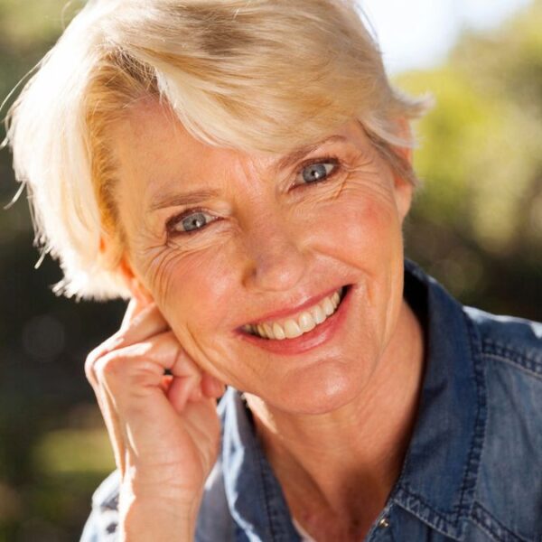 mature woman smiling outside park