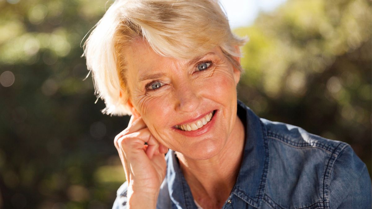 mature woman smiling outside park