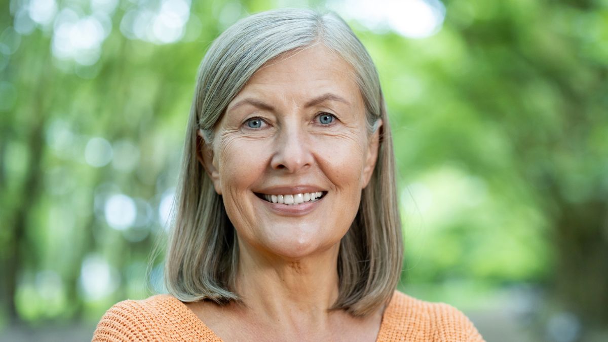 mature woman standing in the garden