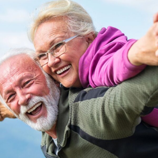 senior couple laughing on a moutain