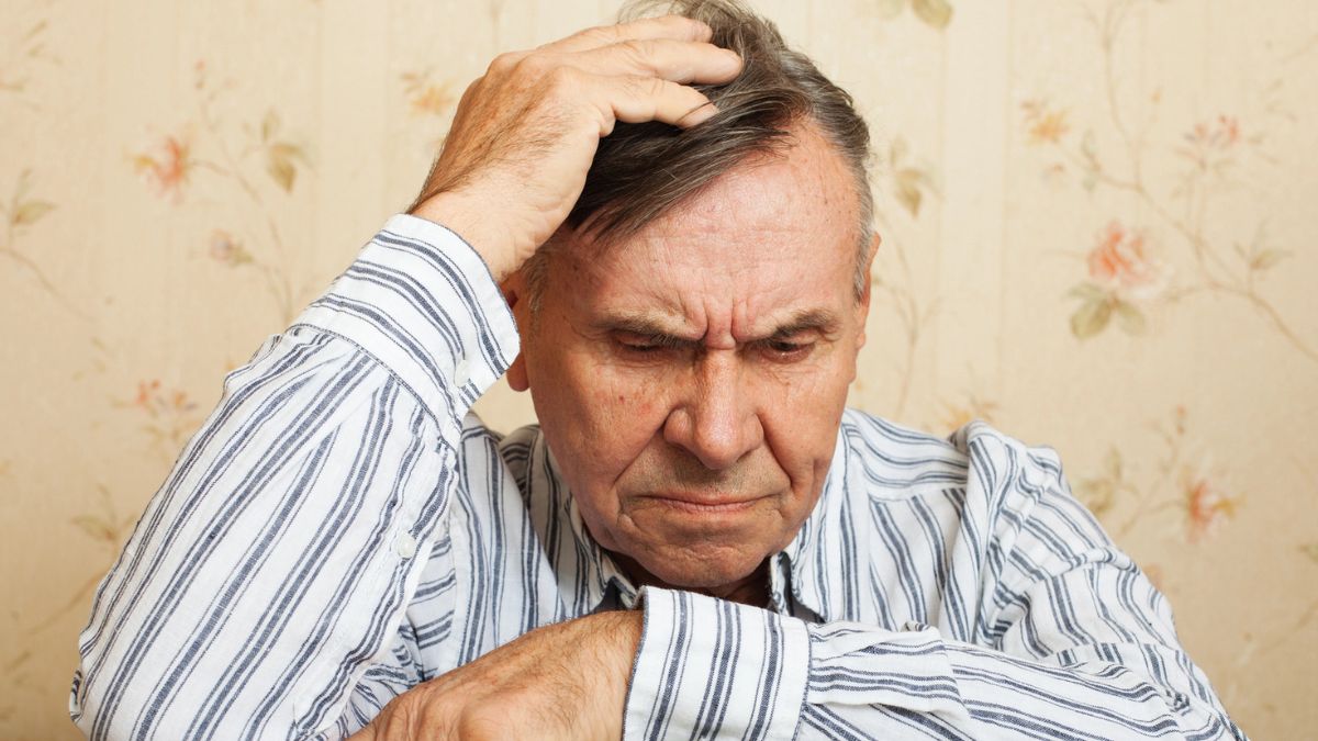 senior man worried on a chair