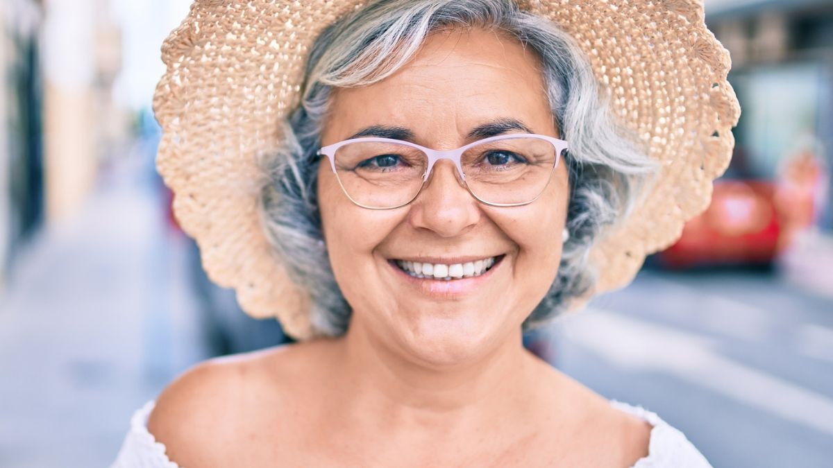senior woman smiling with a hat