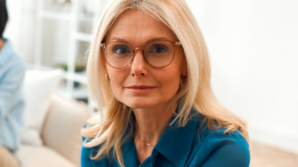 senior woman with glasses couch