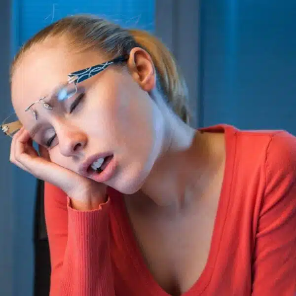 woman bored sleeping on her laptop