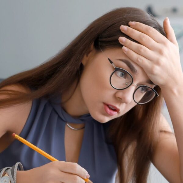 woman desk glasses stressed out laptop