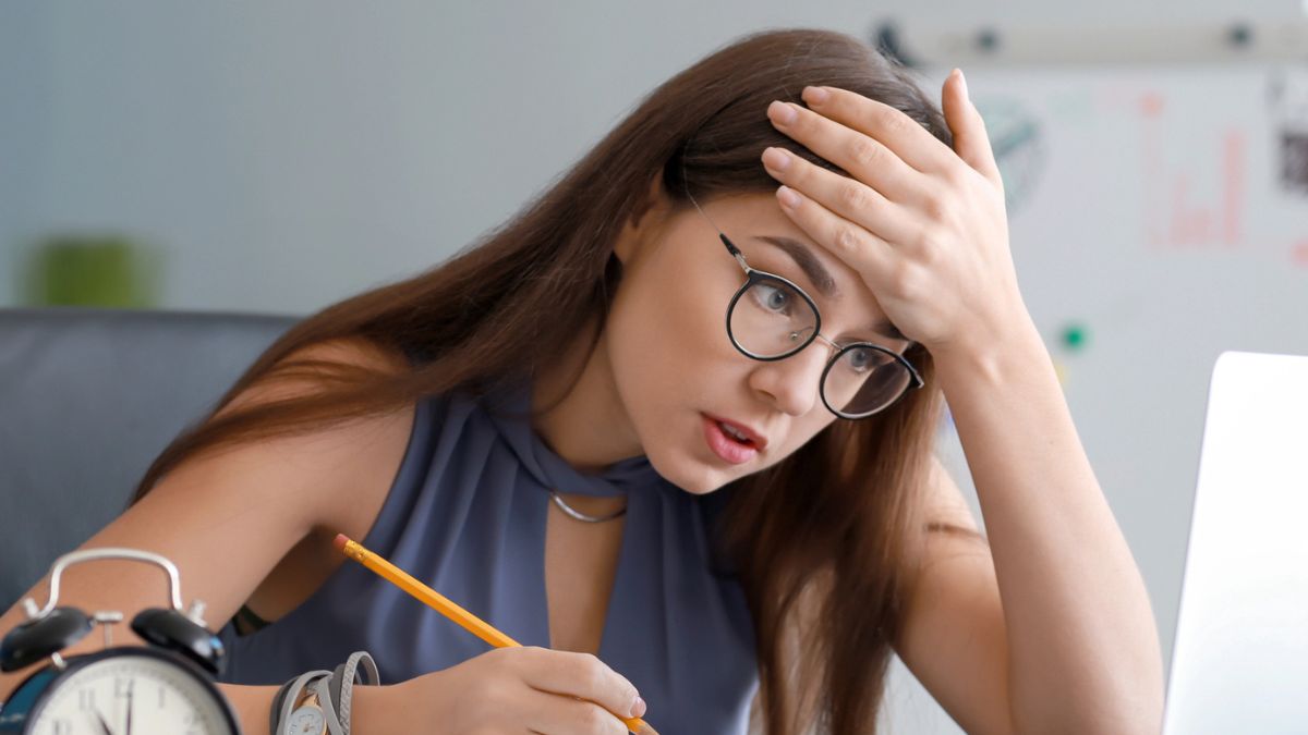 woman desk glasses stressed out laptop
