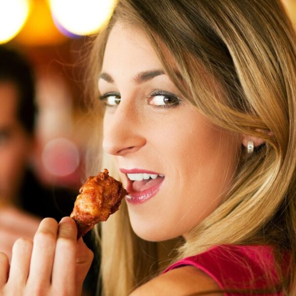 woman eating the check wings