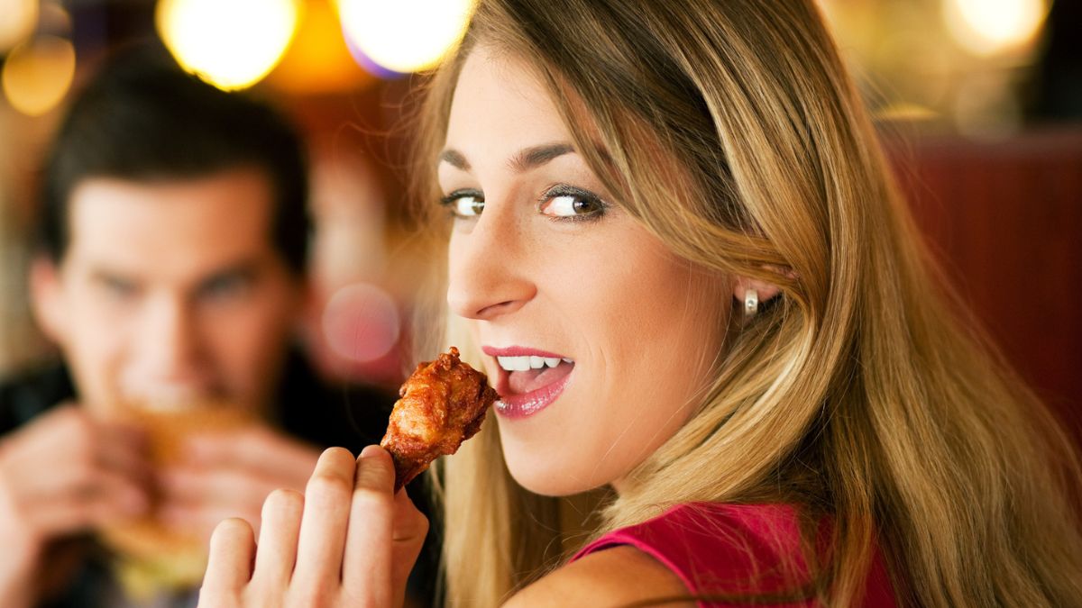 woman eating the check wings