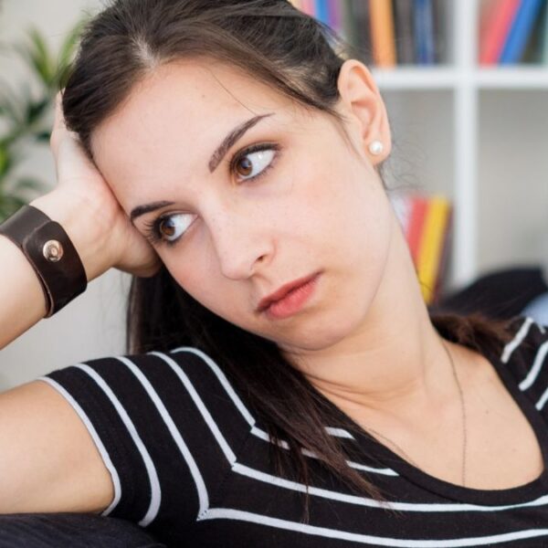 woman feeling lonely on the couch
