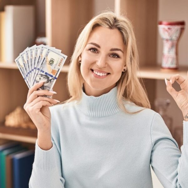 woman holding cash in office