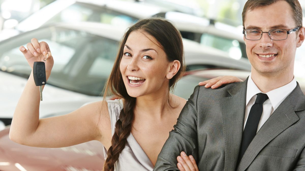 woman holing up car keys