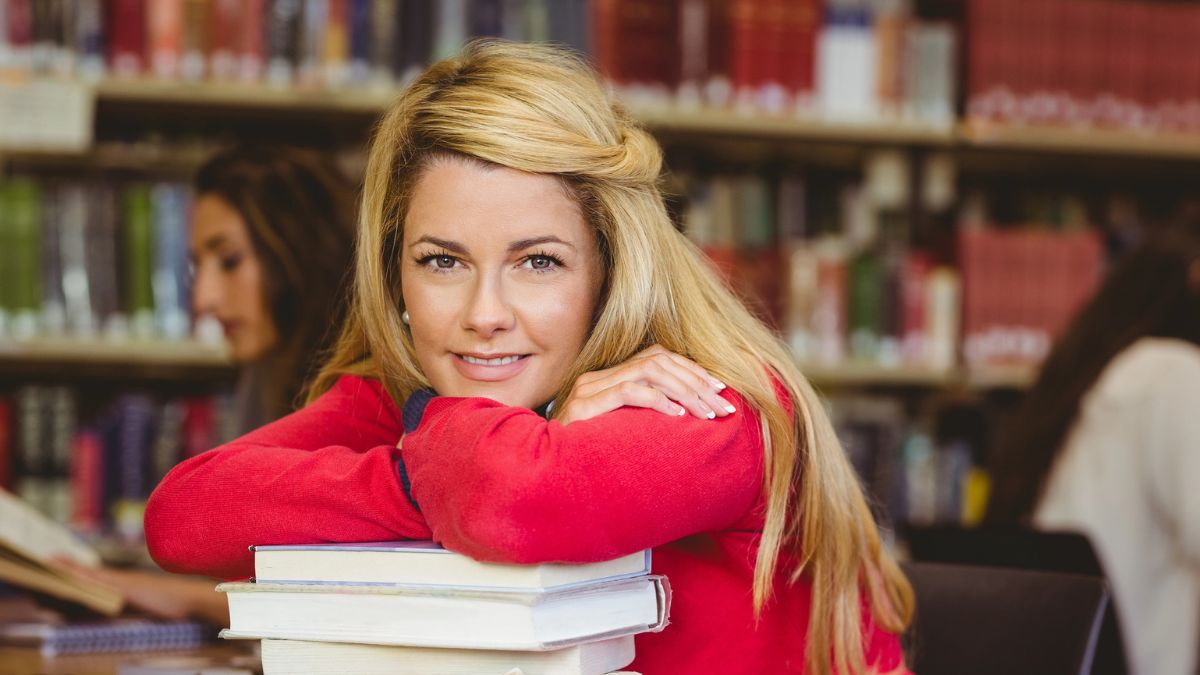 woman in college on books