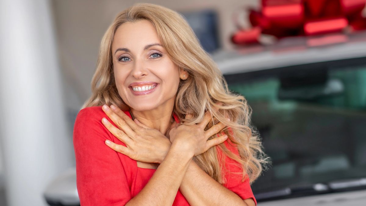 woman in front of new car