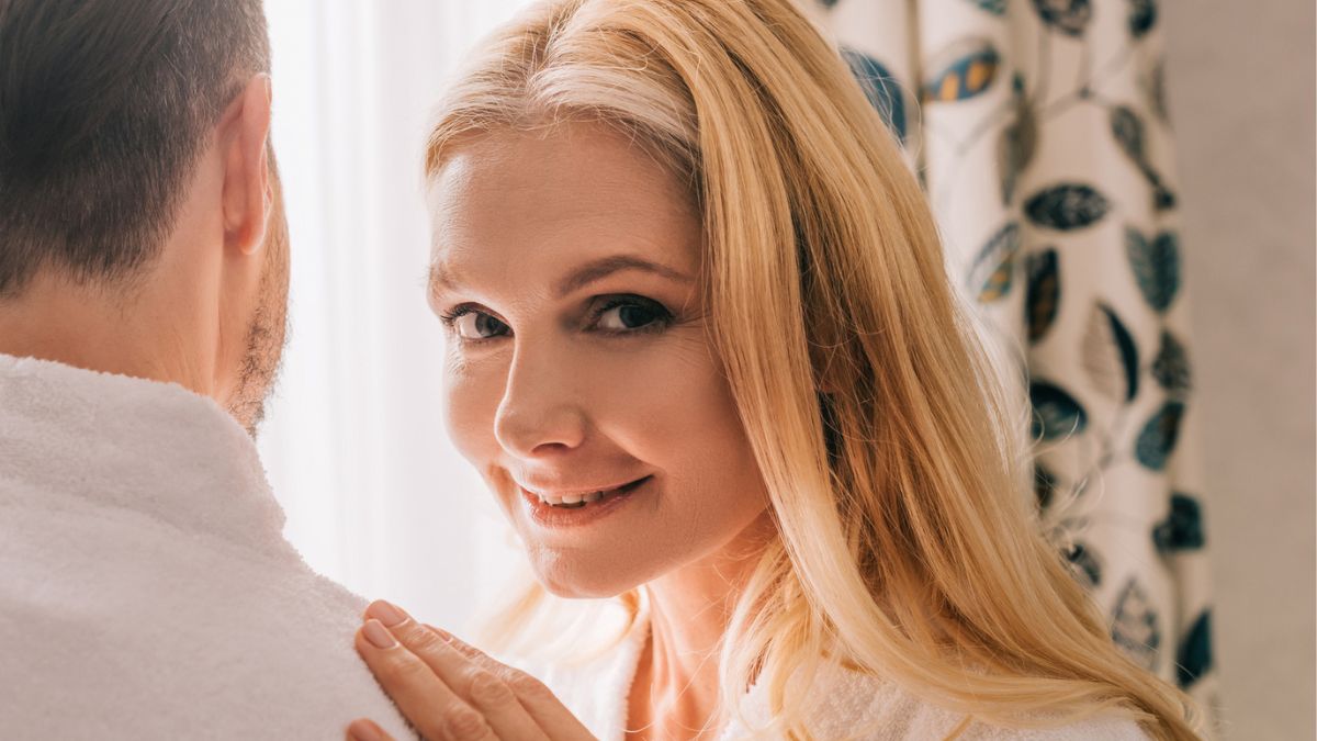 woman in rob smiling with spouse