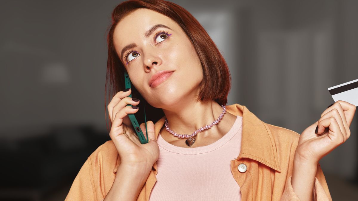 woman on the phone with credit card