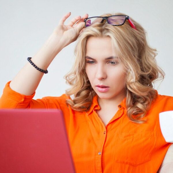 woman orange blouse tired