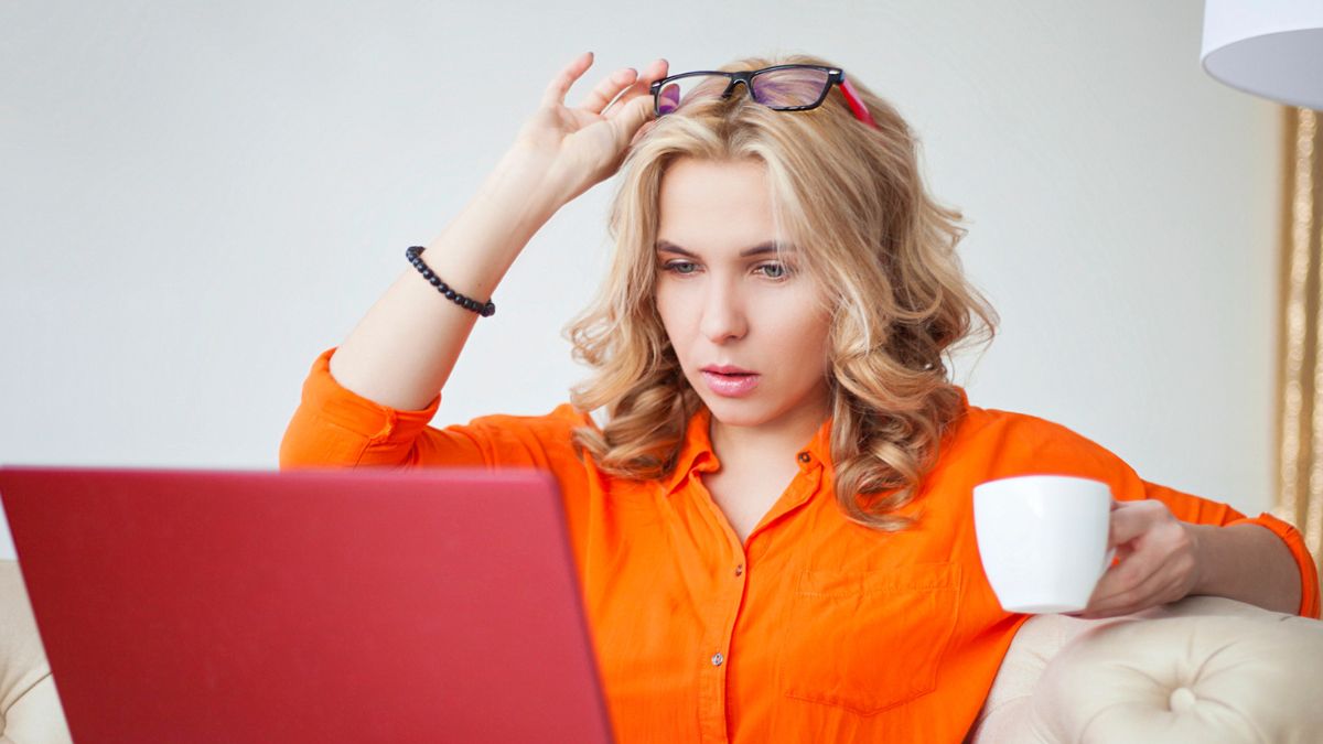 woman orange blouse tired