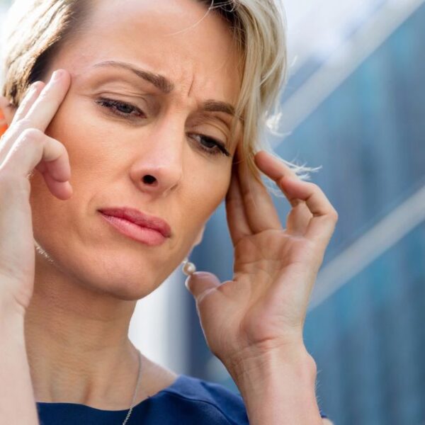 woman outside with a headache