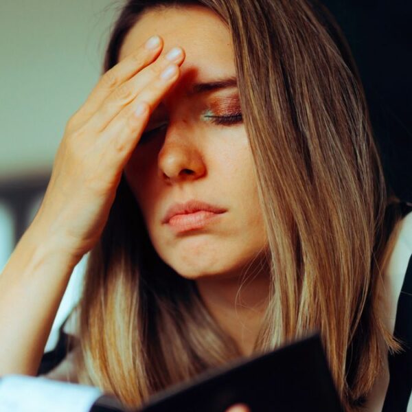 woman overwhelmed with checkbook