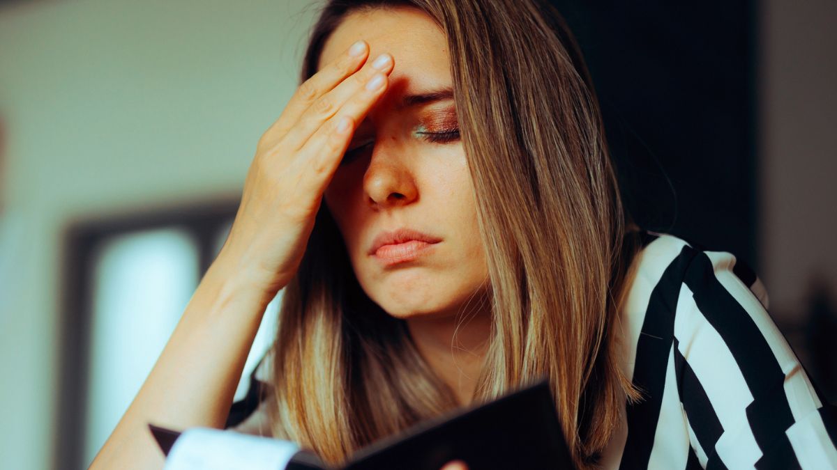woman overwhelmed with checkbook