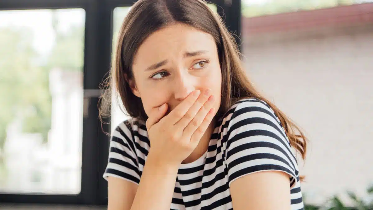 woman shock covering her mouth