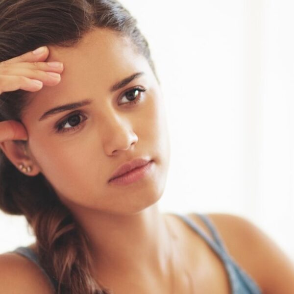 woman sitting alone on bed