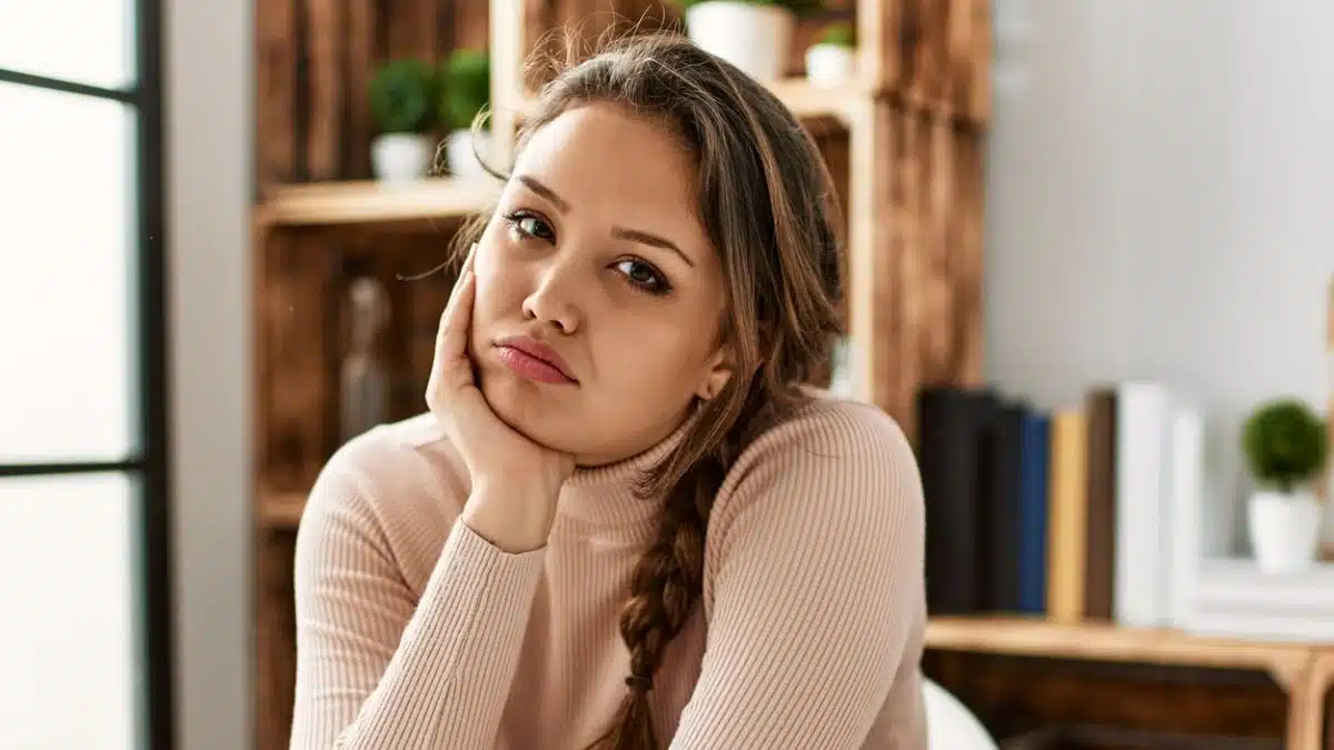 woman sitting leaning on the kitchen counter