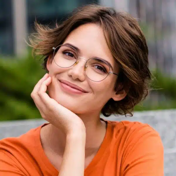 woman sitting on steps smiling glasses