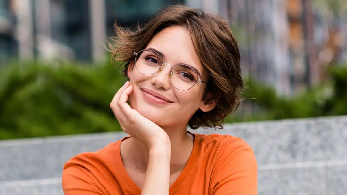 woman sitting on steps smiling glasses