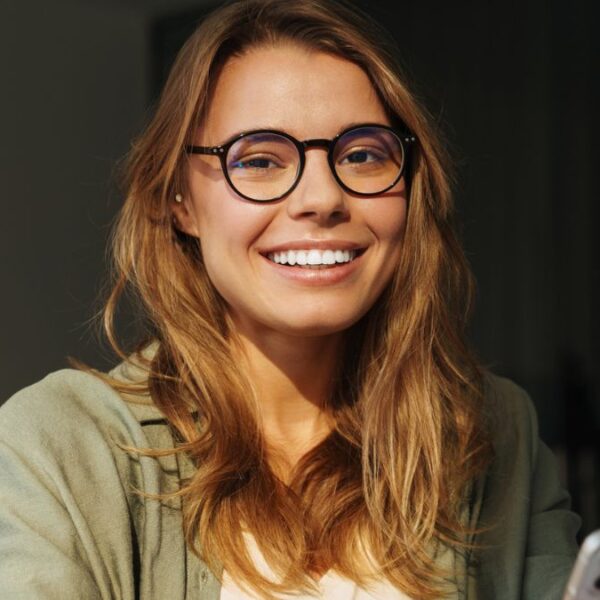 woman smiling with her phone