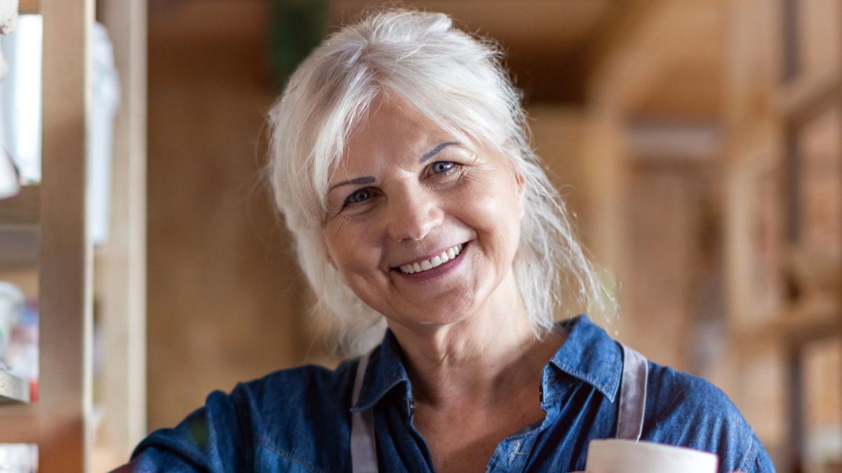 woman smiling with pottery