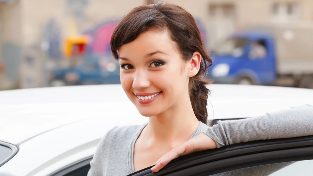 woman standing next to a car