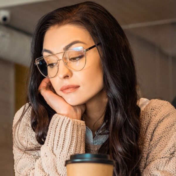 woman staring down coffee
