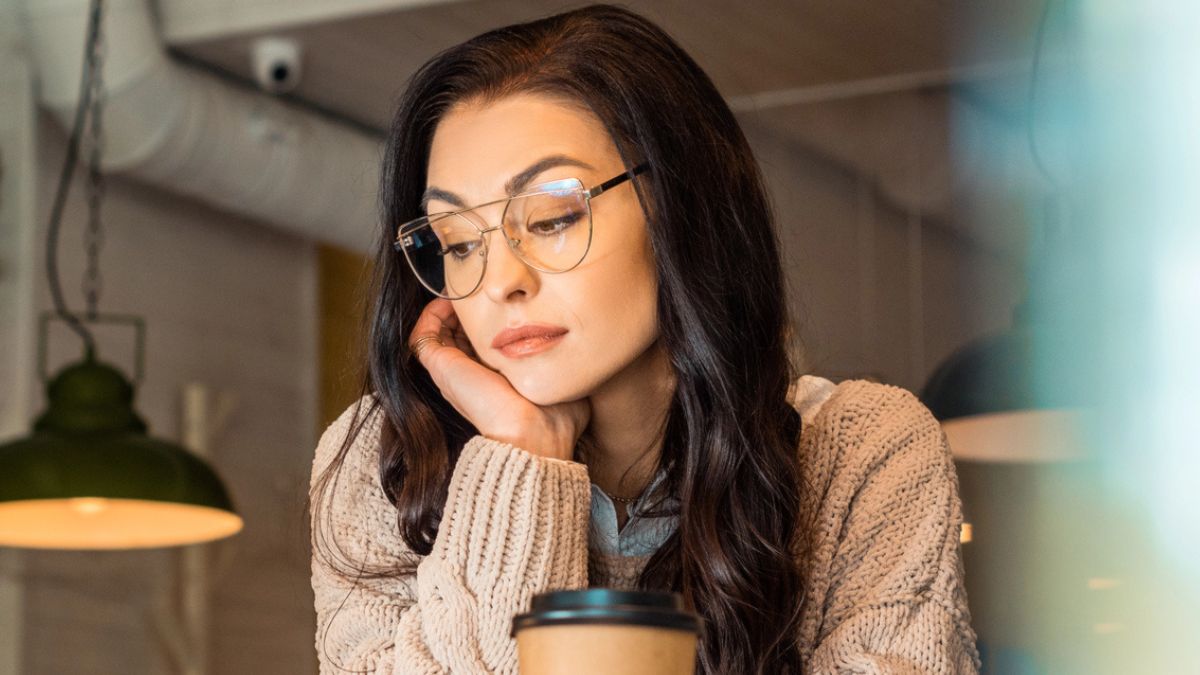 woman staring down coffee