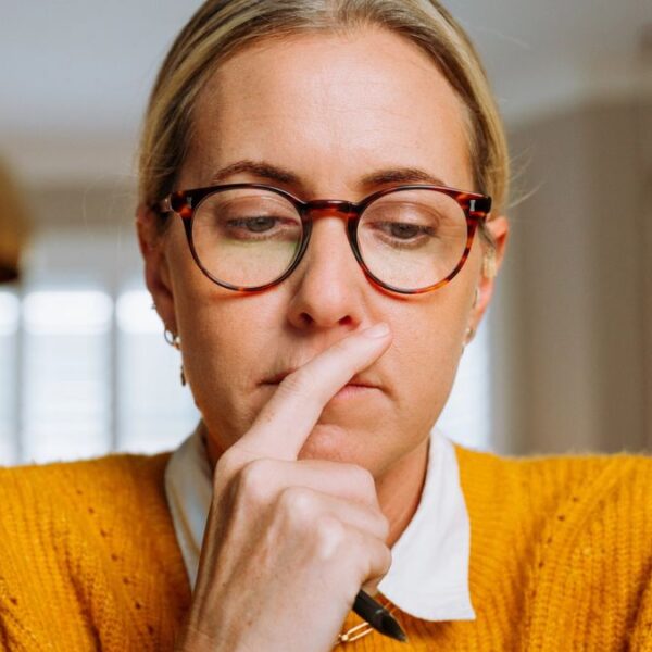 woman staring glasses at her laptop