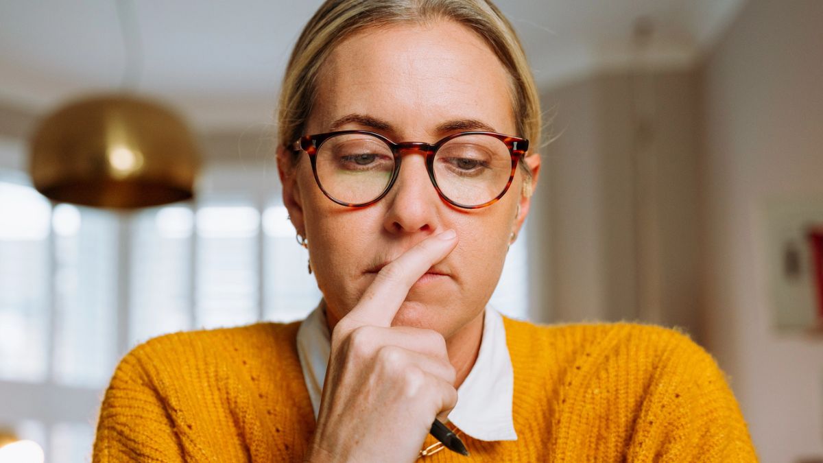 woman staring glasses at her laptop