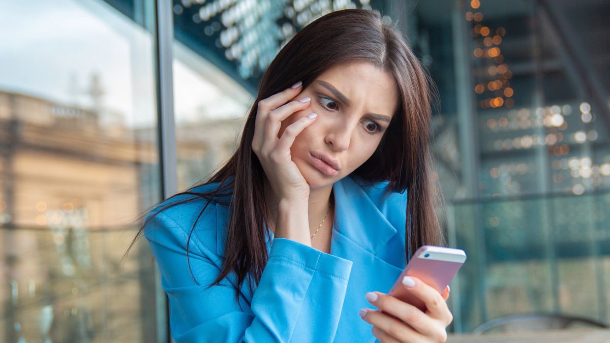 woman stressed looking at her phone (1)