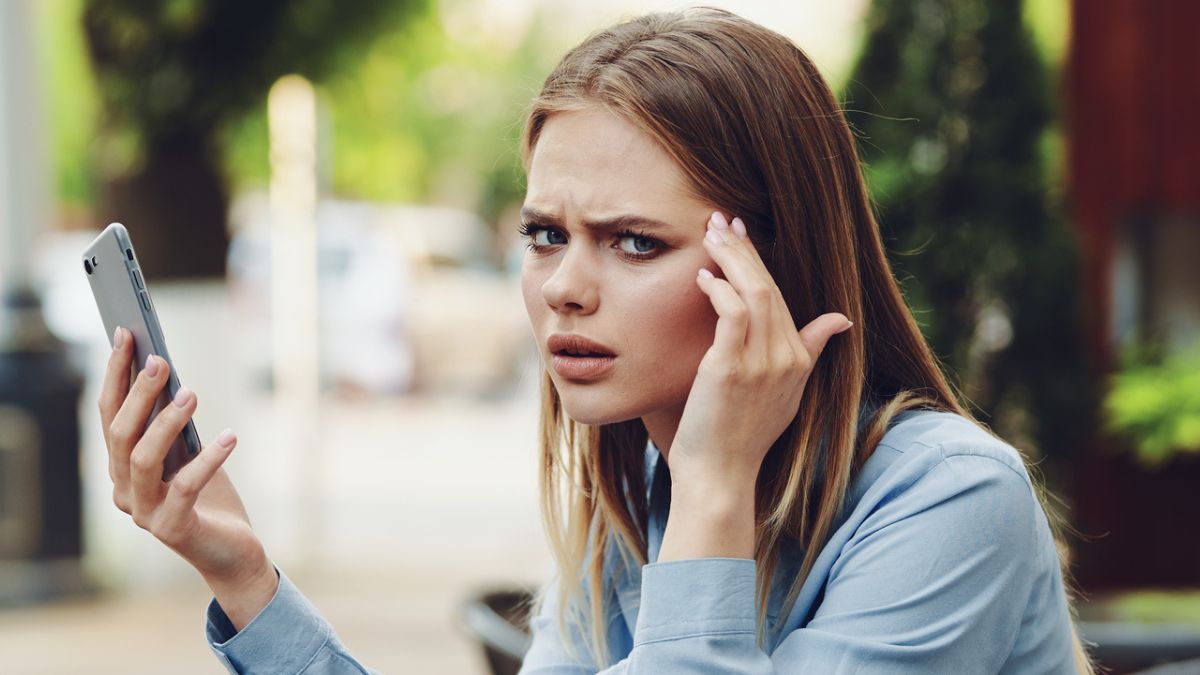 woman stressed looking at her phone